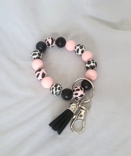 Bracelet porte-clés à imprimé animal rose, blanc et noir.